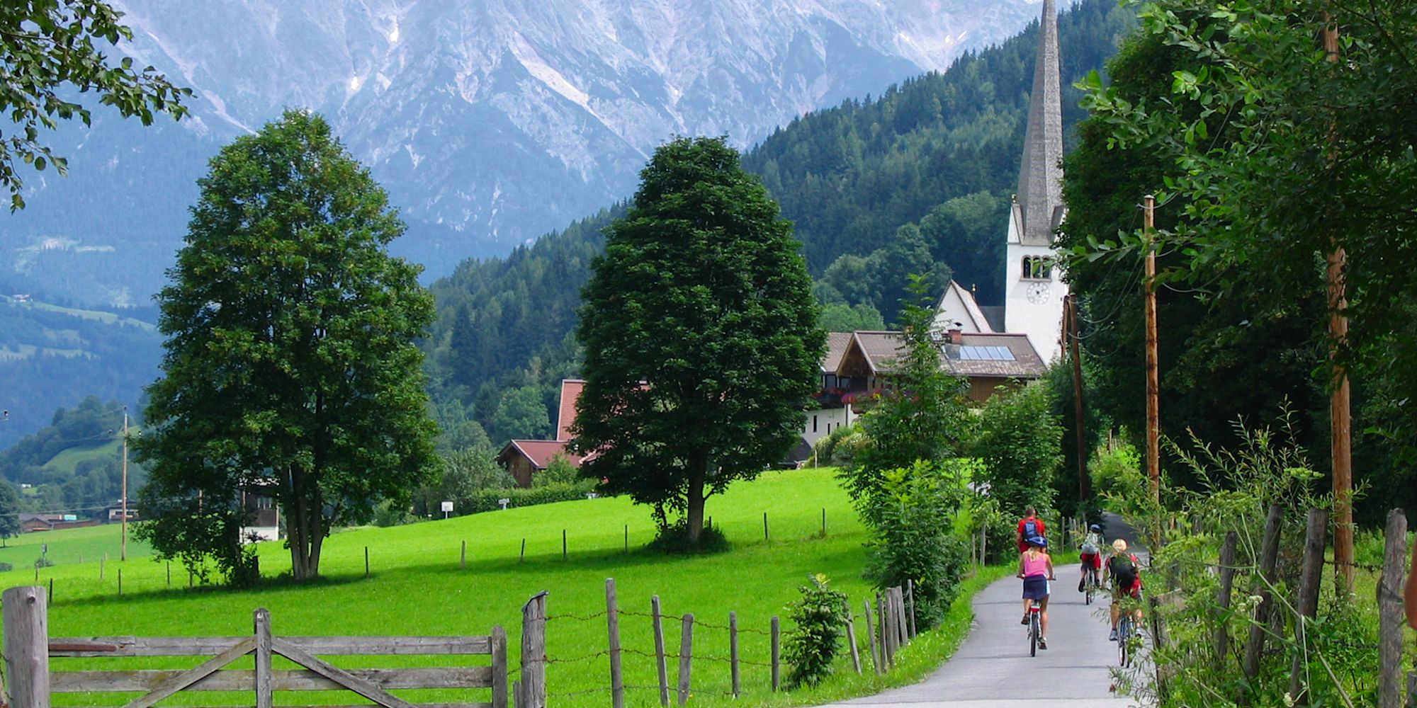 Guests cycling beneath the Austrian Alps on the Austria Family Vacation